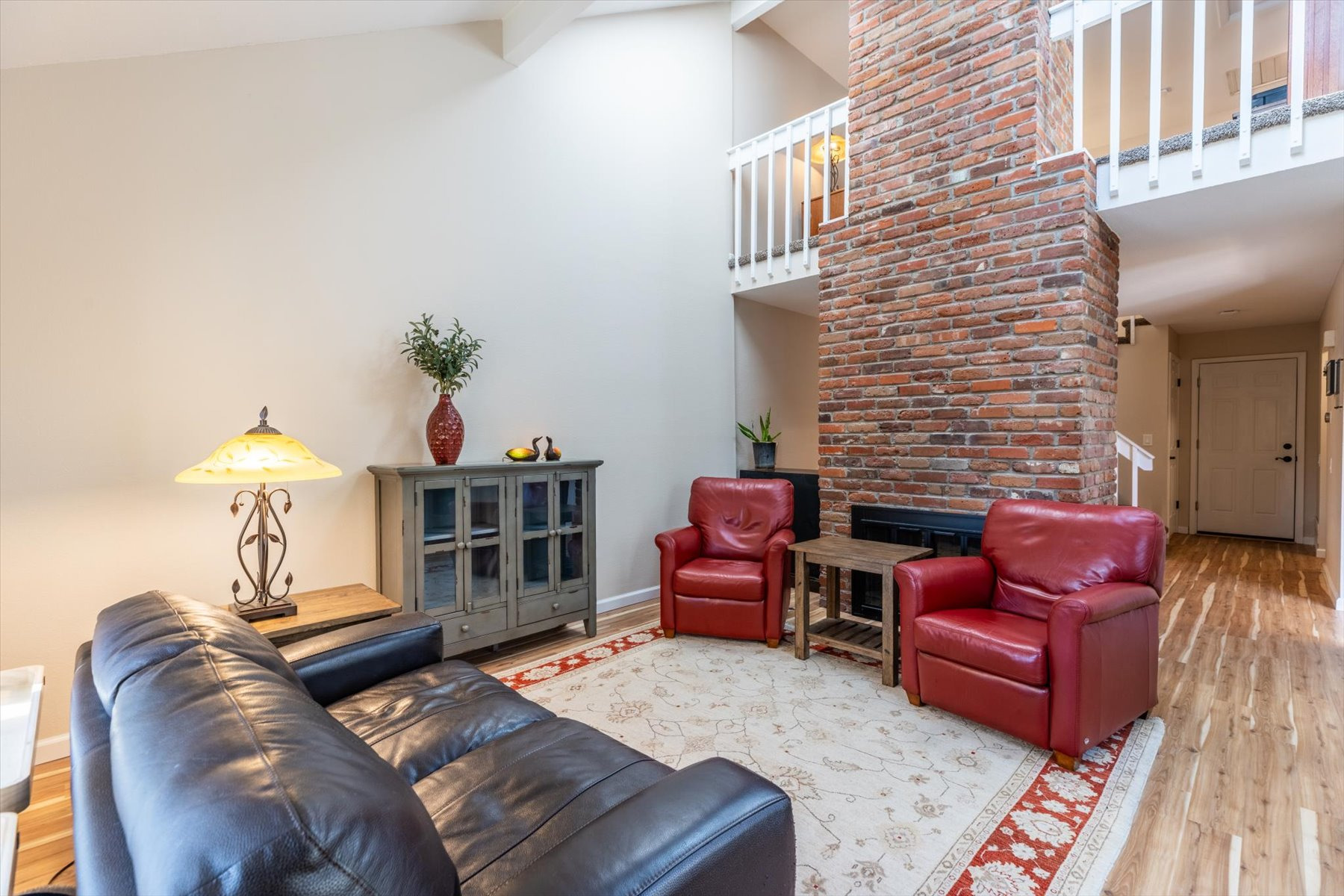 Lovely living room with beautiful brick fireplace