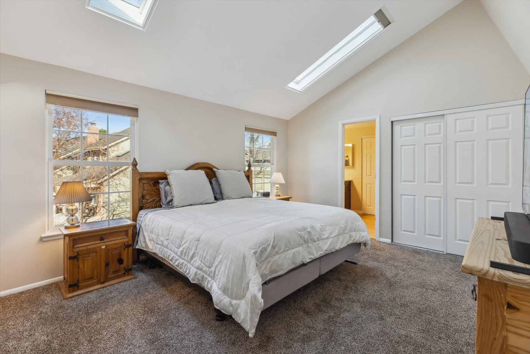 Primary Suite has 2 closets with organizers, skylights with blinds