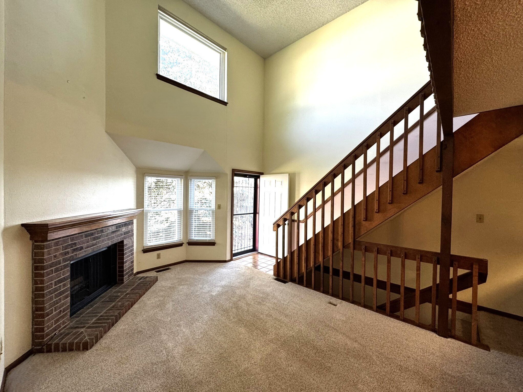 Living Room - High Ceiling and Wood Fireplace
