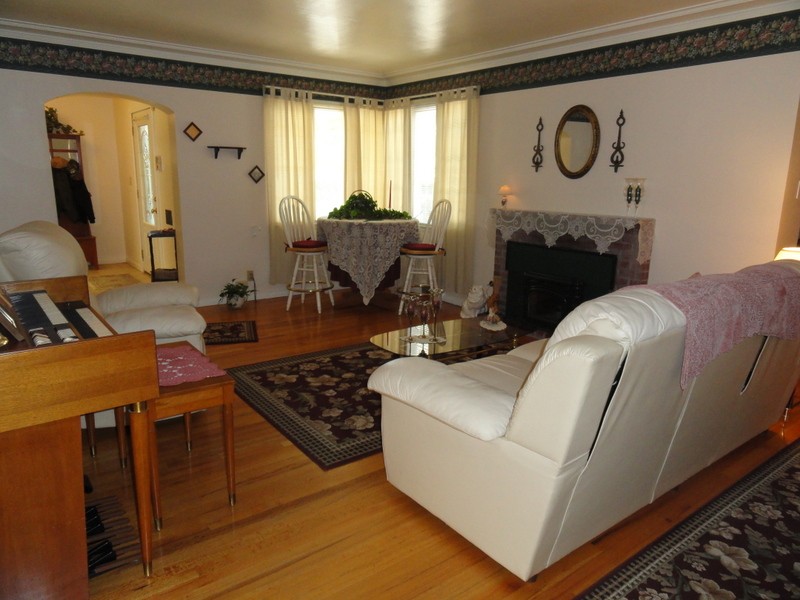 Formal living room with beautiful wood floors and a fireplac