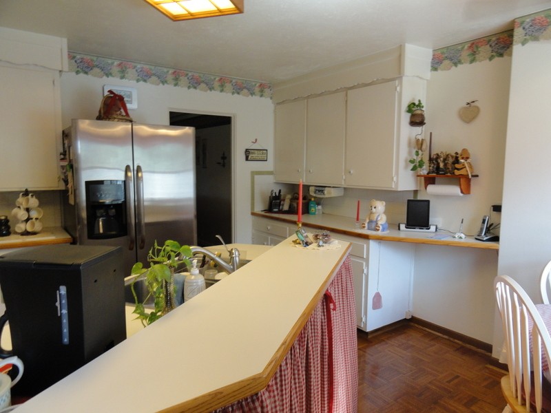 Cute country kitchen with an island!  Gingham not included!