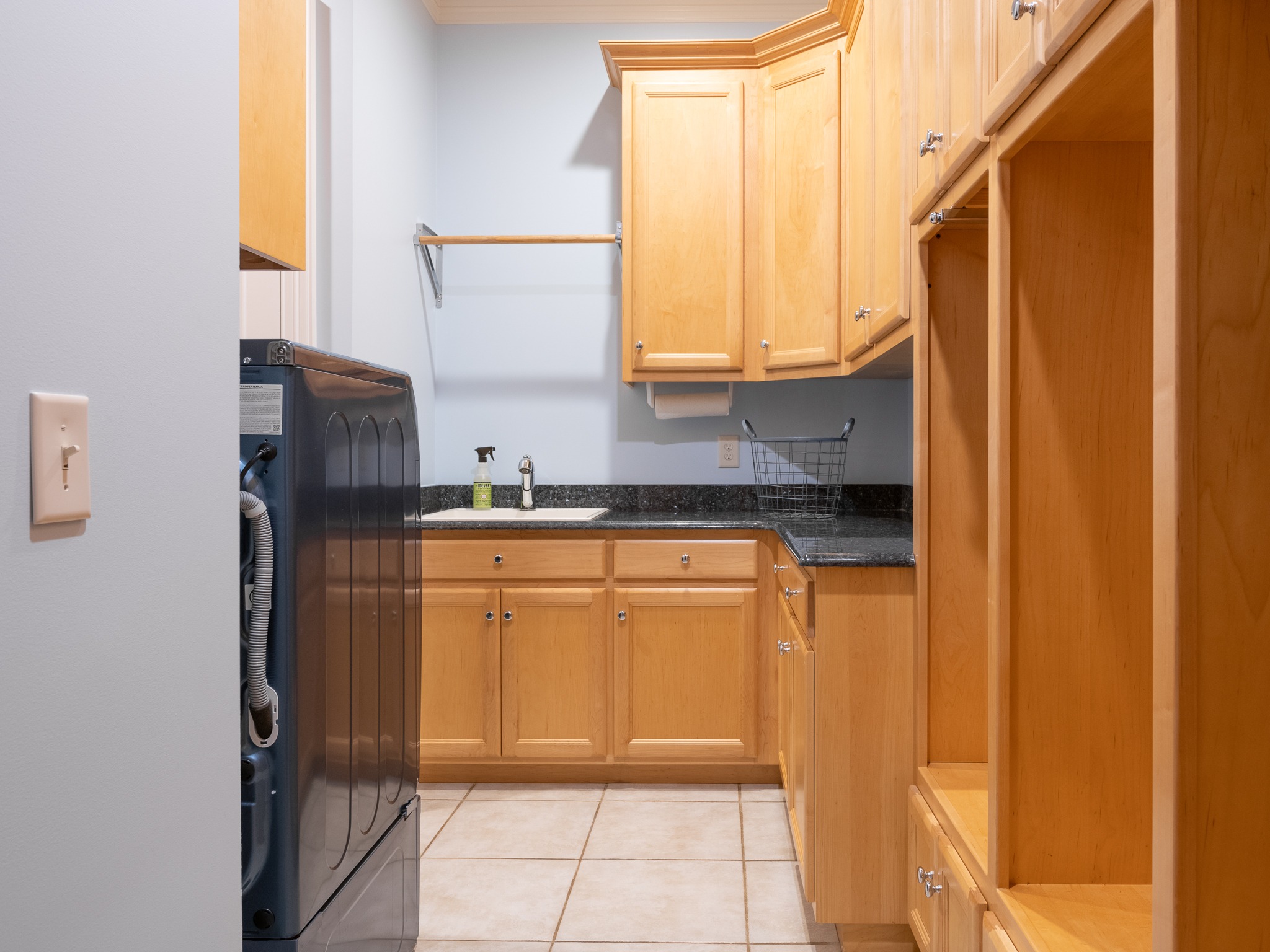 Laundry with sink, cubbies, and cabinet pantry