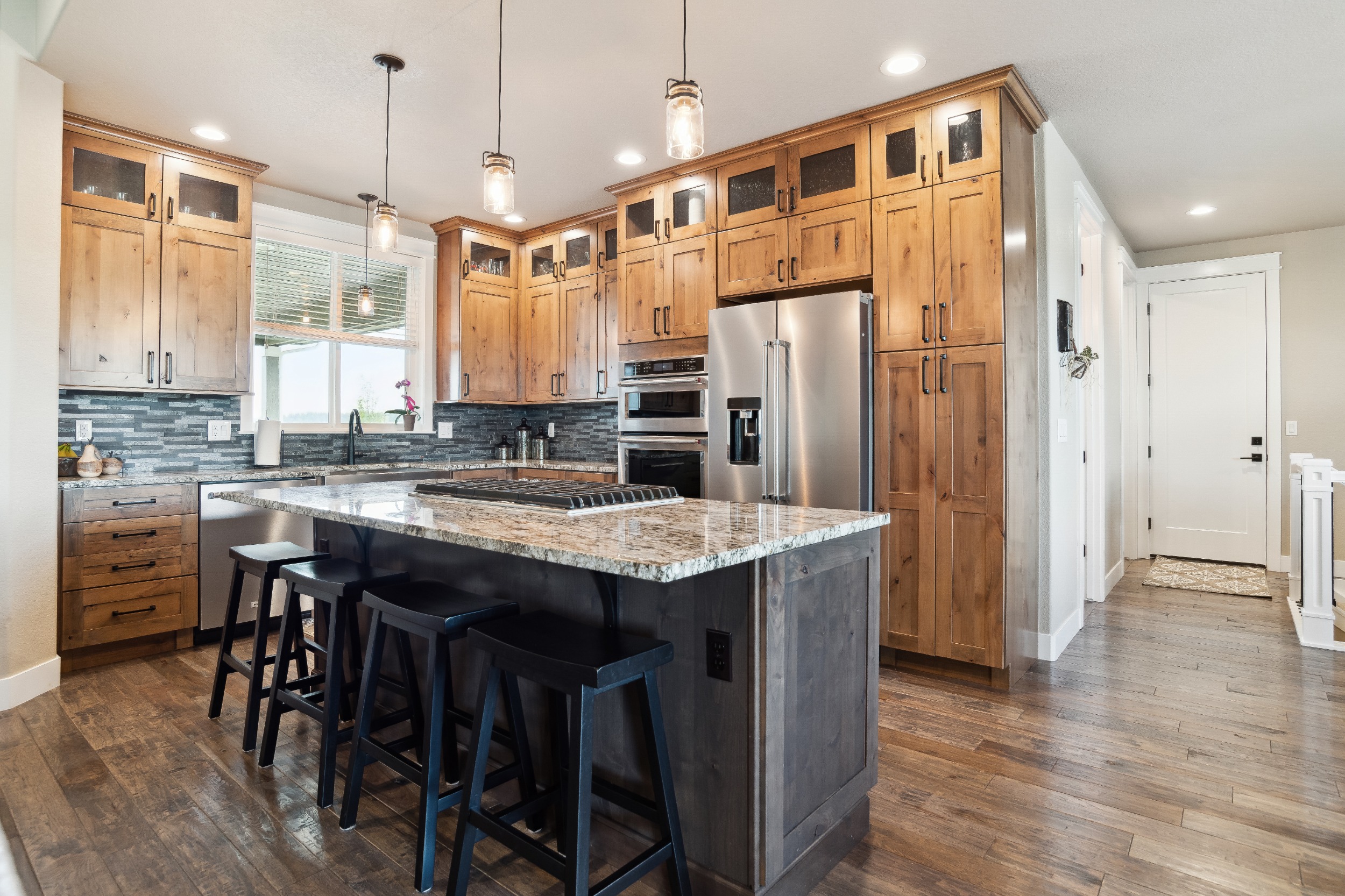 Knotty Alder Cabinets with pull out shelves, Farmhouse Sink, Kitchen Aid Appliances and Granite Counters