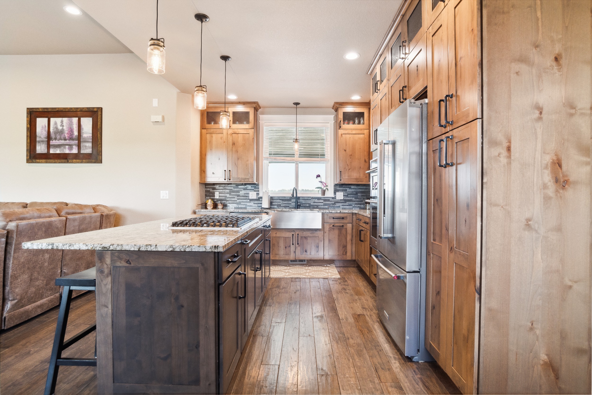Knotty Alder Cabinets with pull out shelves, Farmhouse Sink, Kitchen Aid Appliances and Granite Counters