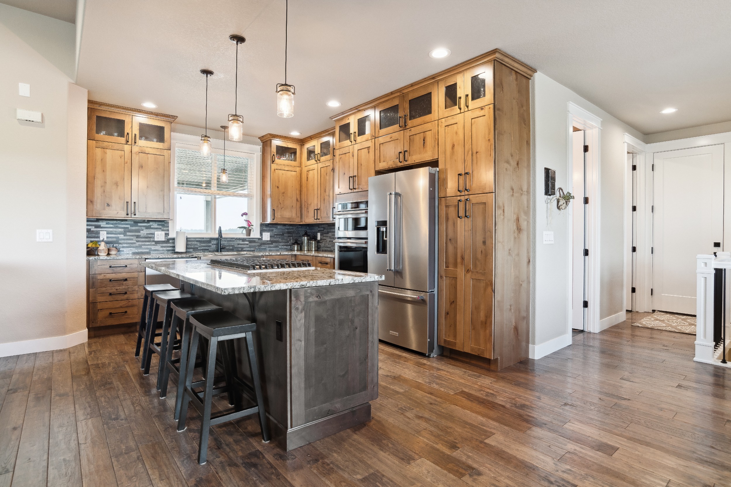 Knotty Alder Cabinets with pull out shelves, Farmhouse Sink, Kitchen Aid Appliances and Granite Counters