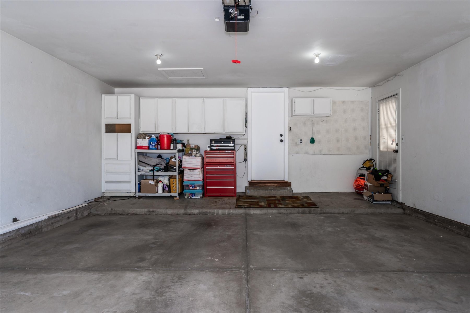 Large Garage with Cabinets and Service Door