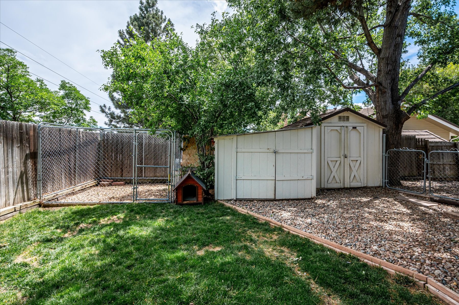 Two Storage Sheds and 10 x 10 Dog Run in Backyard