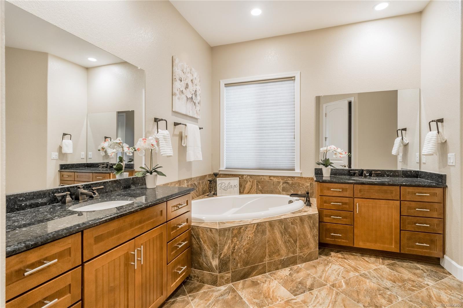 Master bath with heated Italian slate flooring, emerald pearl granite and large shower with double shower heads.