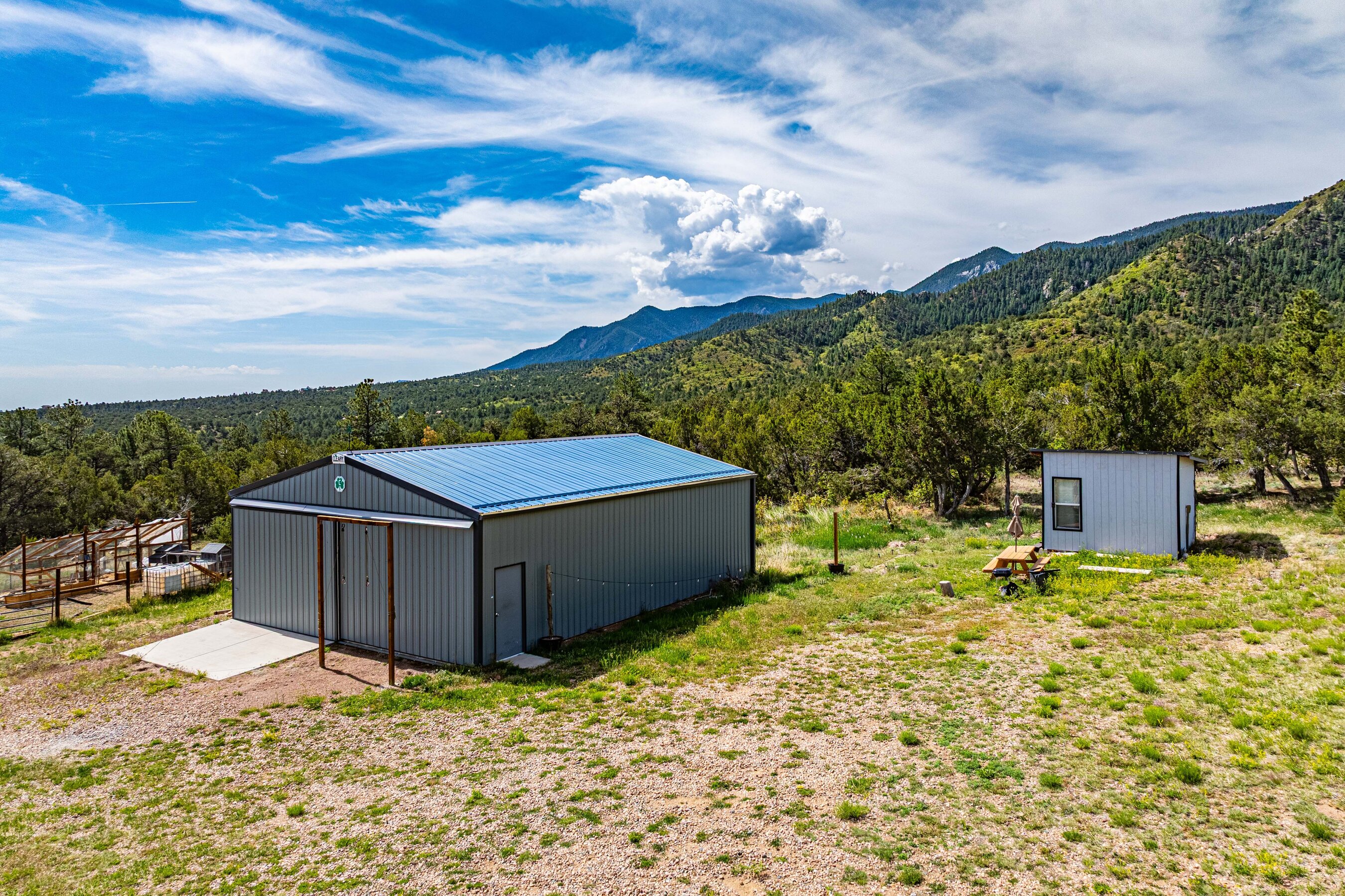 Adjacent to the barn is a 1/4 fenced pasture area, 2 chicken coops, RV parking hookup, and a cabin/studio for projects or guests.