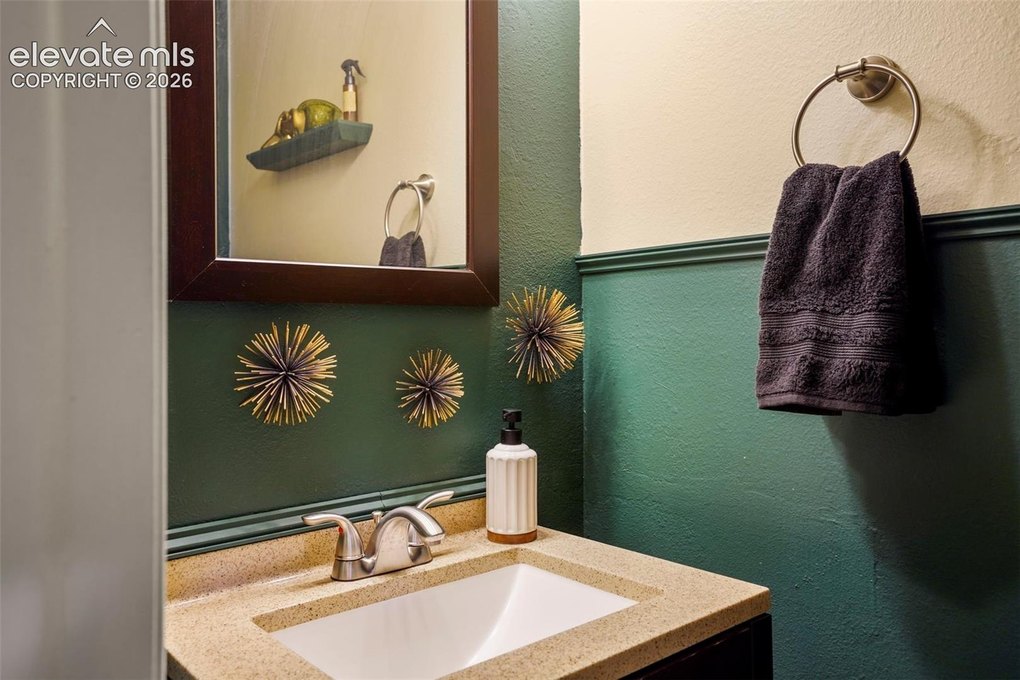 Updated half bath on the main including solid surface counters. 