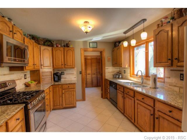 Kitchen with large window above sink and entry to pantry area (which leads to ga