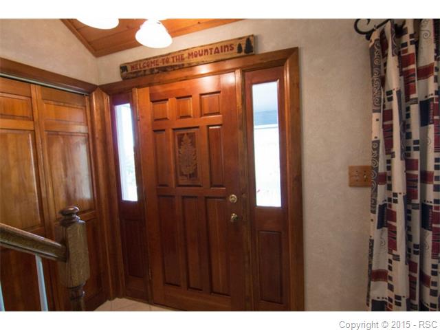 Wooden front door and coat closet.