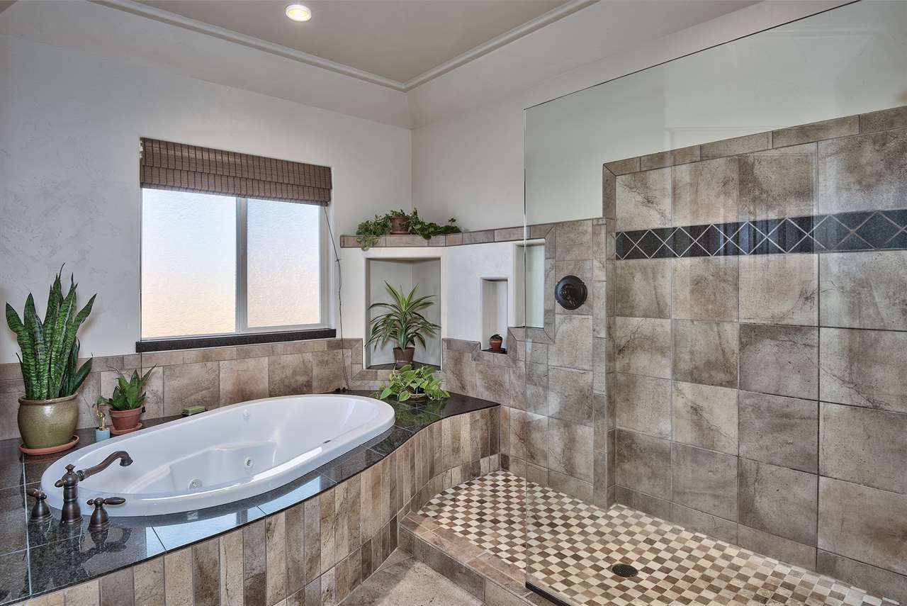 The oversized soaker bathtub in the master suite is richly finished & paired to 