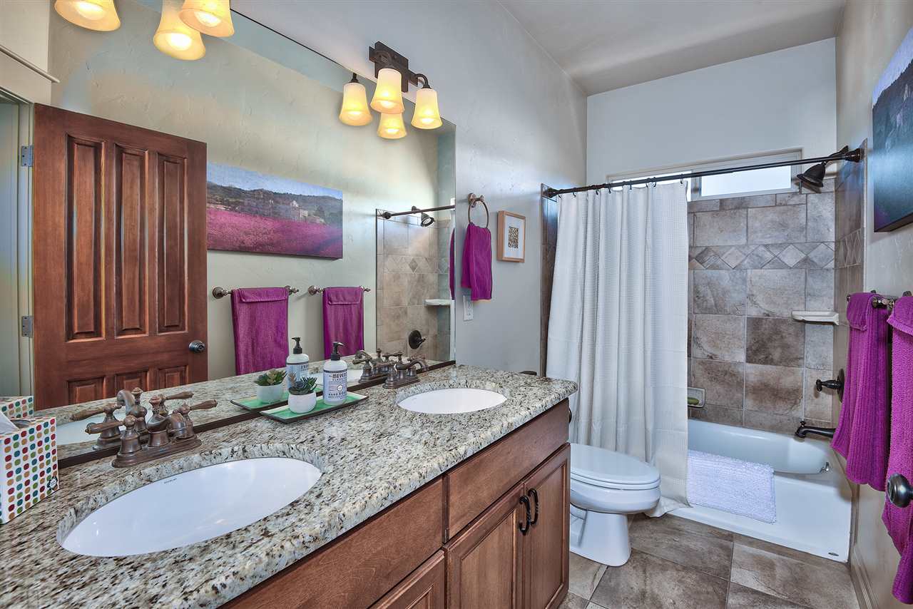 The full guest bathroom also offers dual sink vanities and granite countertops!