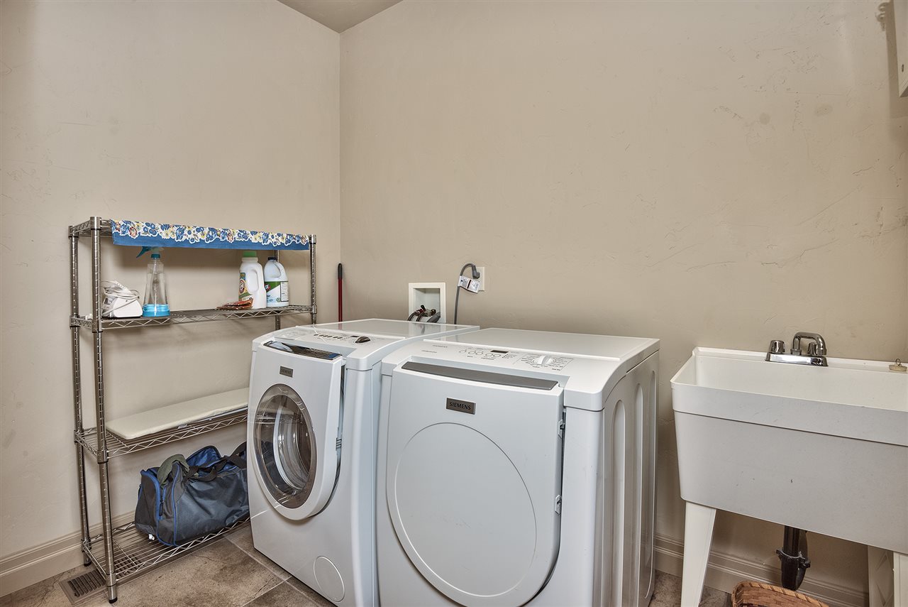 The spacious laundry room is located near the master suite and includes a laundr