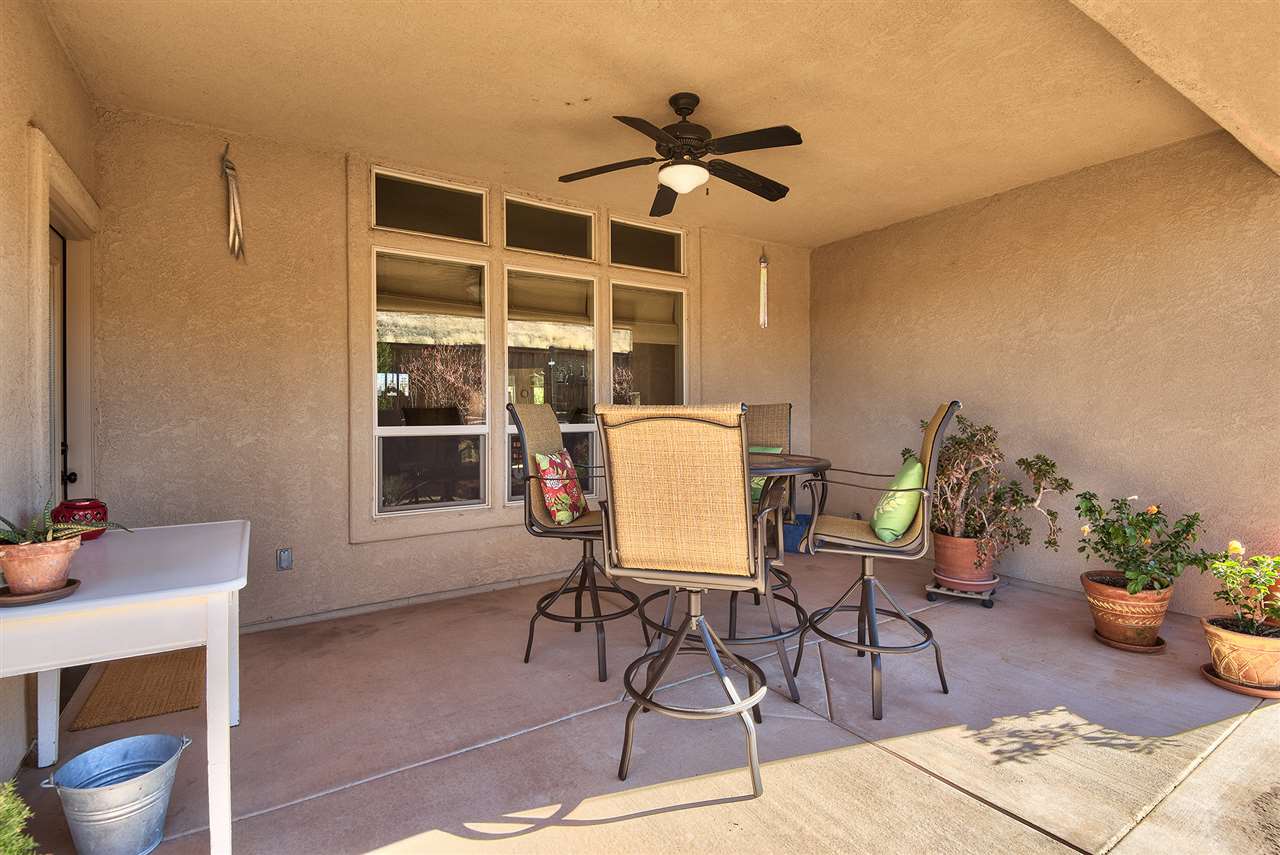 The roomy covered rear patio is cooled with an outdoor ceiling fan and is perfec