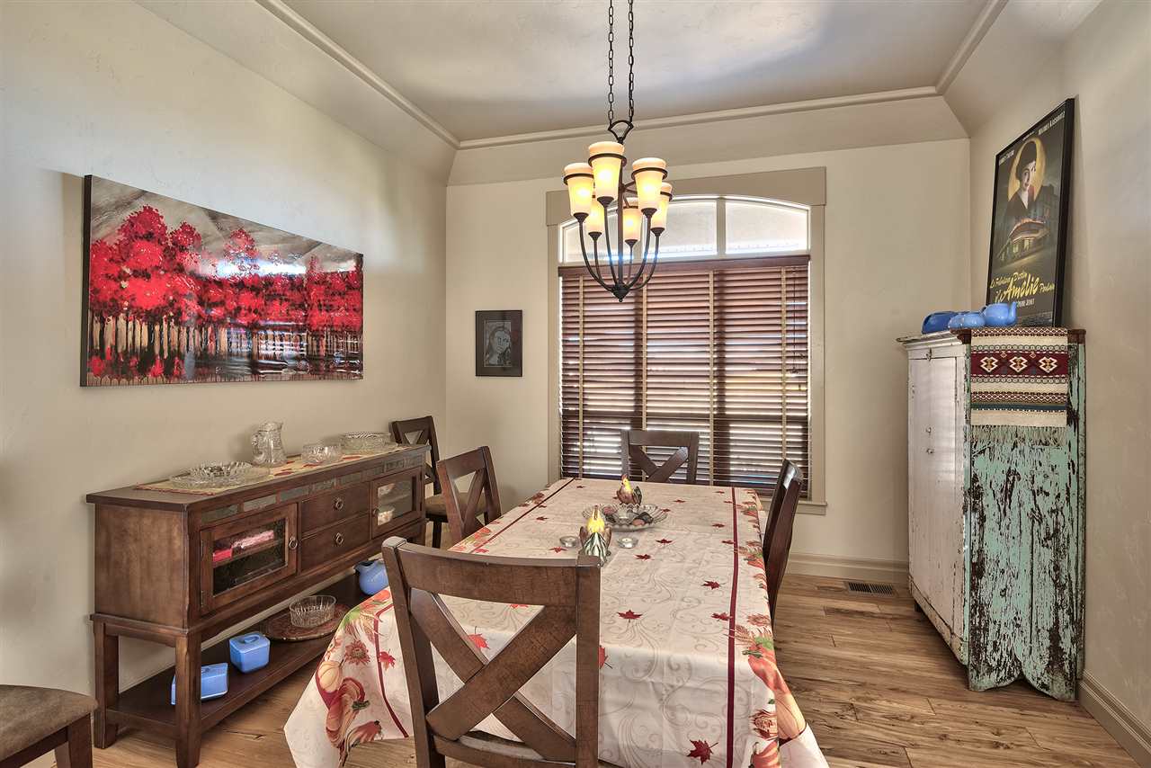 Hardwood flooring is paired to 12-foot coffered ceilings in a dining room you'll