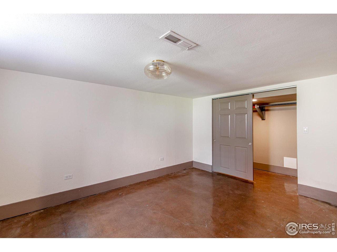 Lower level large BR with concrete floors