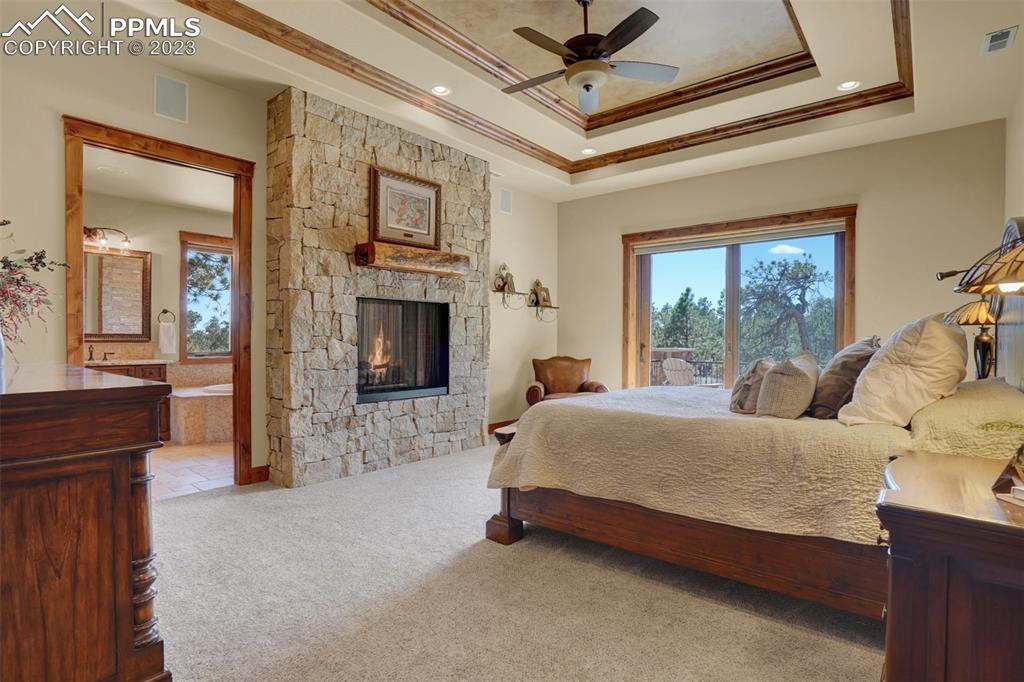 Large Master Suite with 2 Sided Fireplace, Sitting Area, and Walk-Out to Large Covered Stamped Concrete Deck!