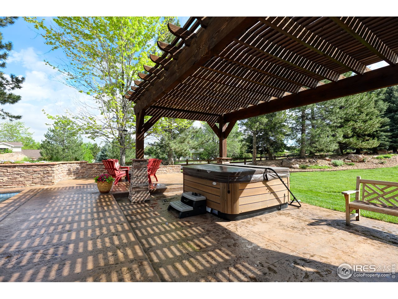 Pergola with hot tub and firepit area