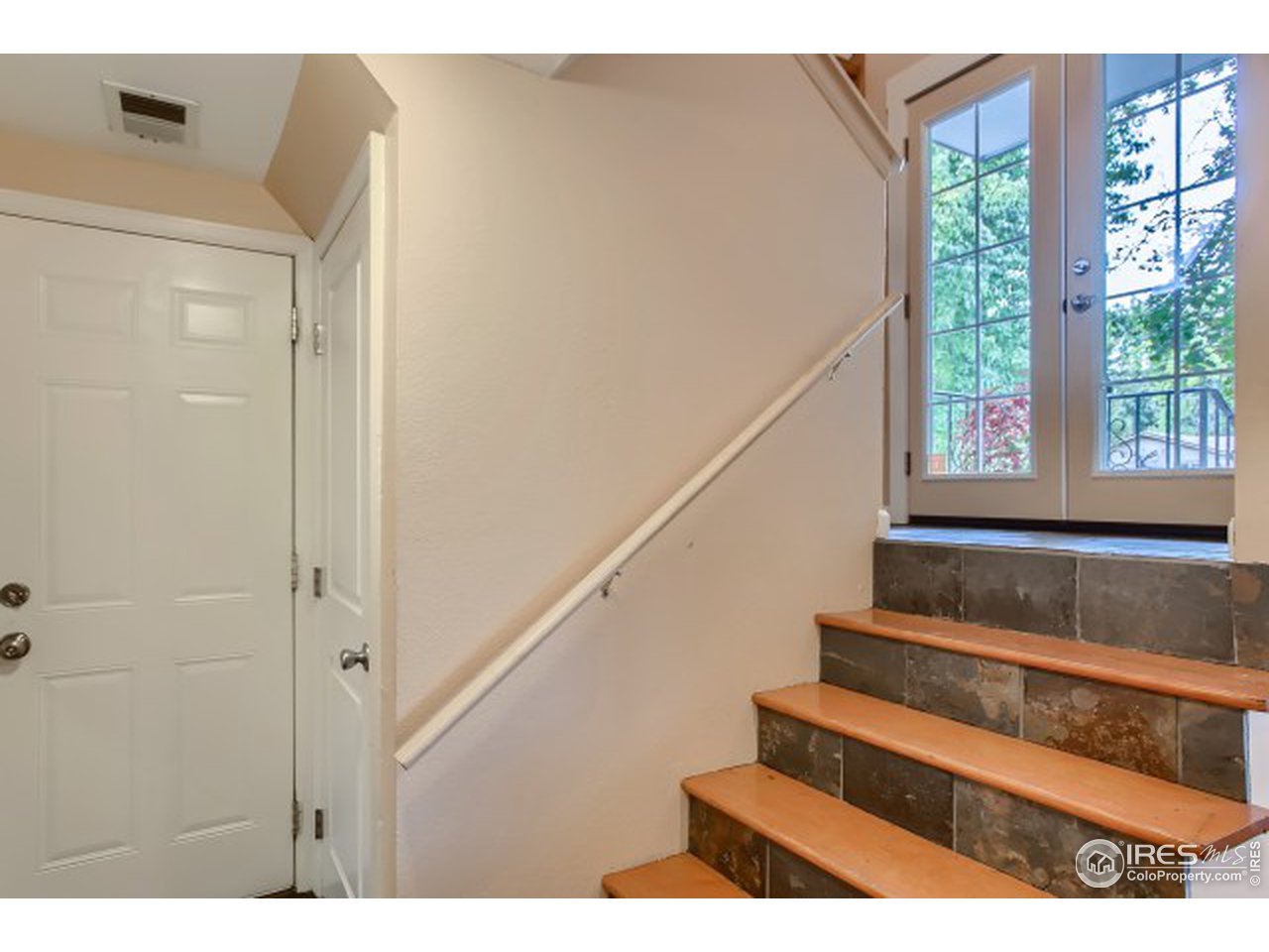 Stairs to lower level, and garage door.