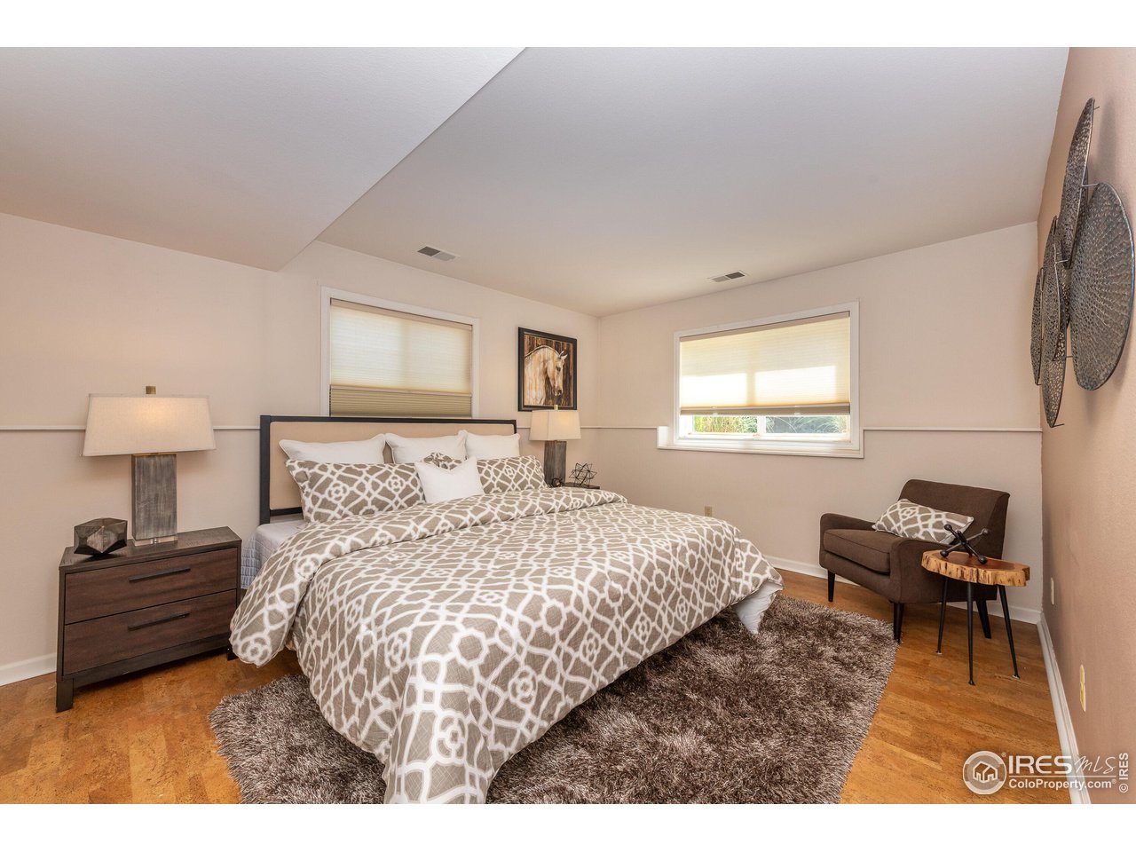 Spacious and airy primary bedroom w/ primary bath and large walk-in closet.