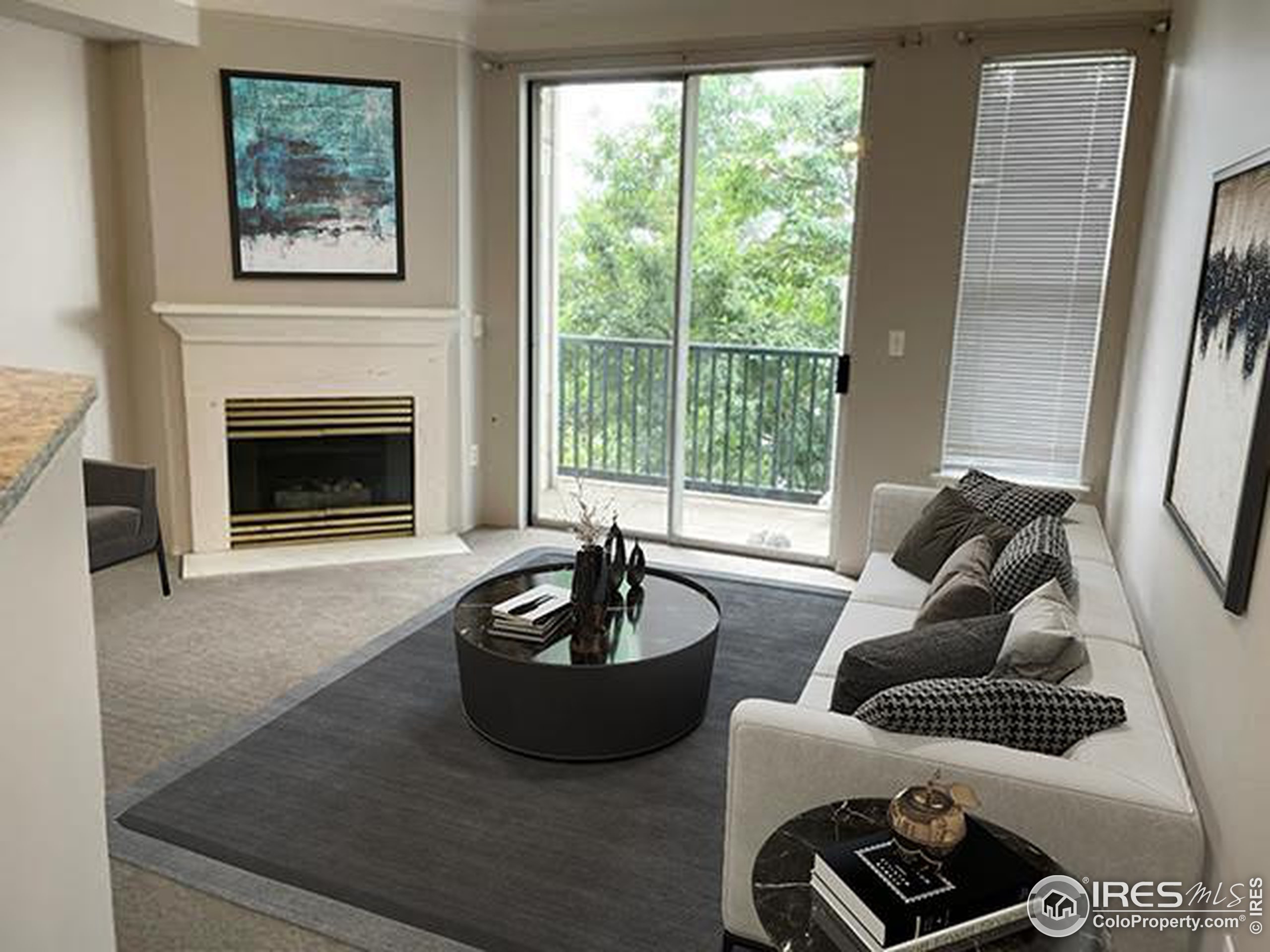 Living room with gas fireplace and balcony