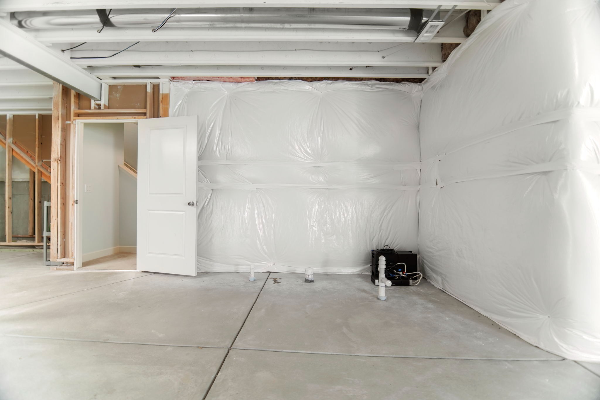 The unfinished basement is prepped for a future bathroom and is already wired for cable and internet. 