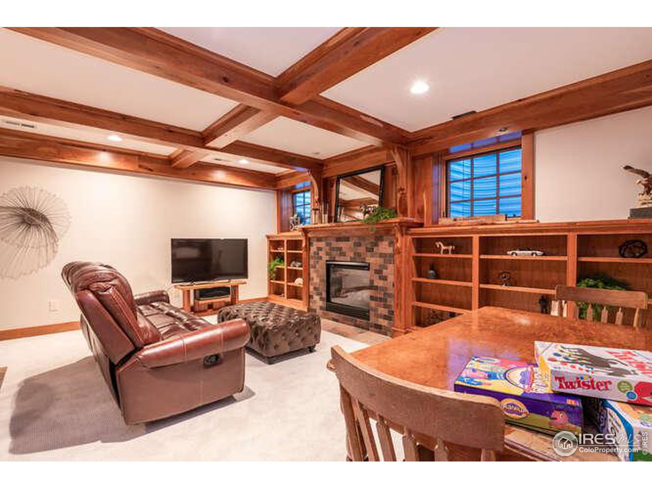 Great room, gas fireplace, built in bookshelves. 