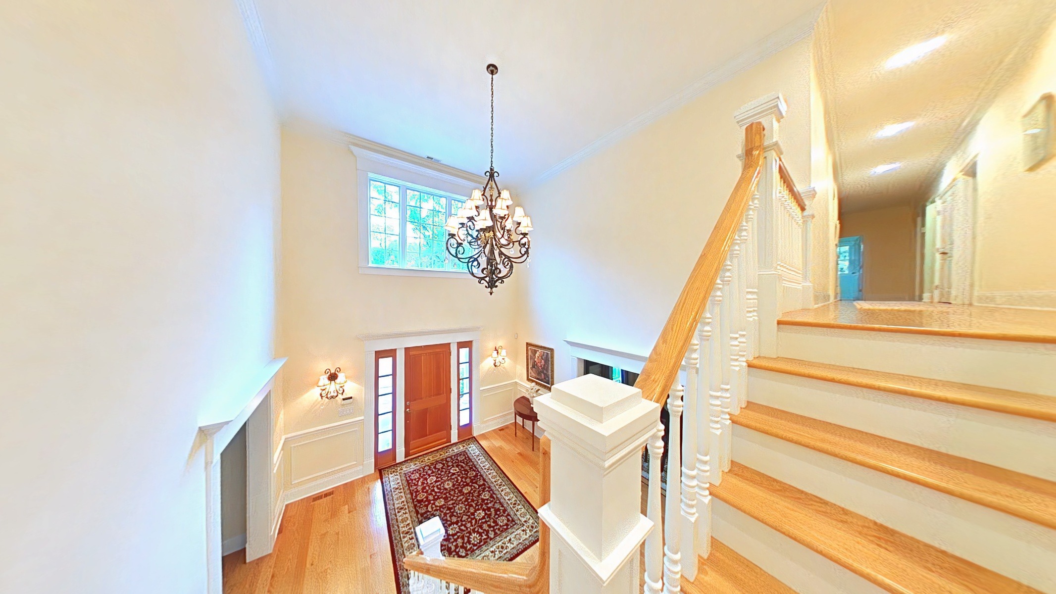 Main staircase to bedrooms and laundry room.  Remote chandelier in foyer (for easy cleaning).