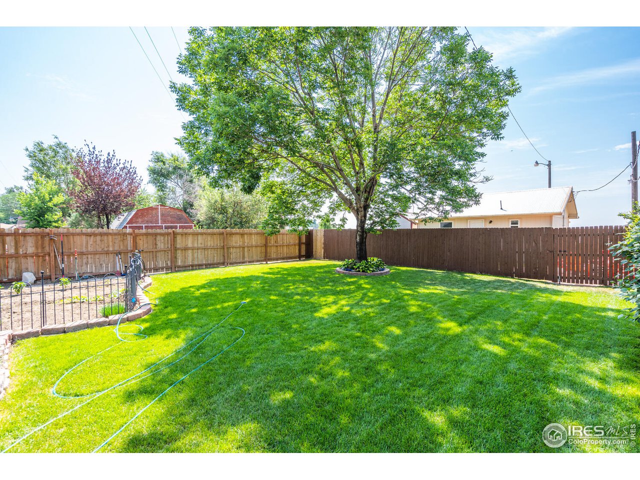 Fully fenced private backyard with mature landscaping and trees!