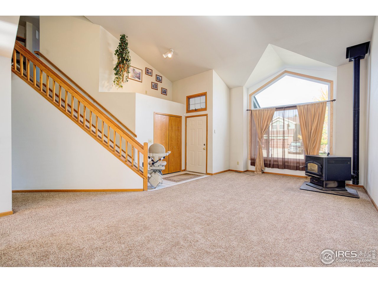 Walking through the front door, be sure to note the large windows, pellet stove, vaulted ceilings, & new carpet & pad. 