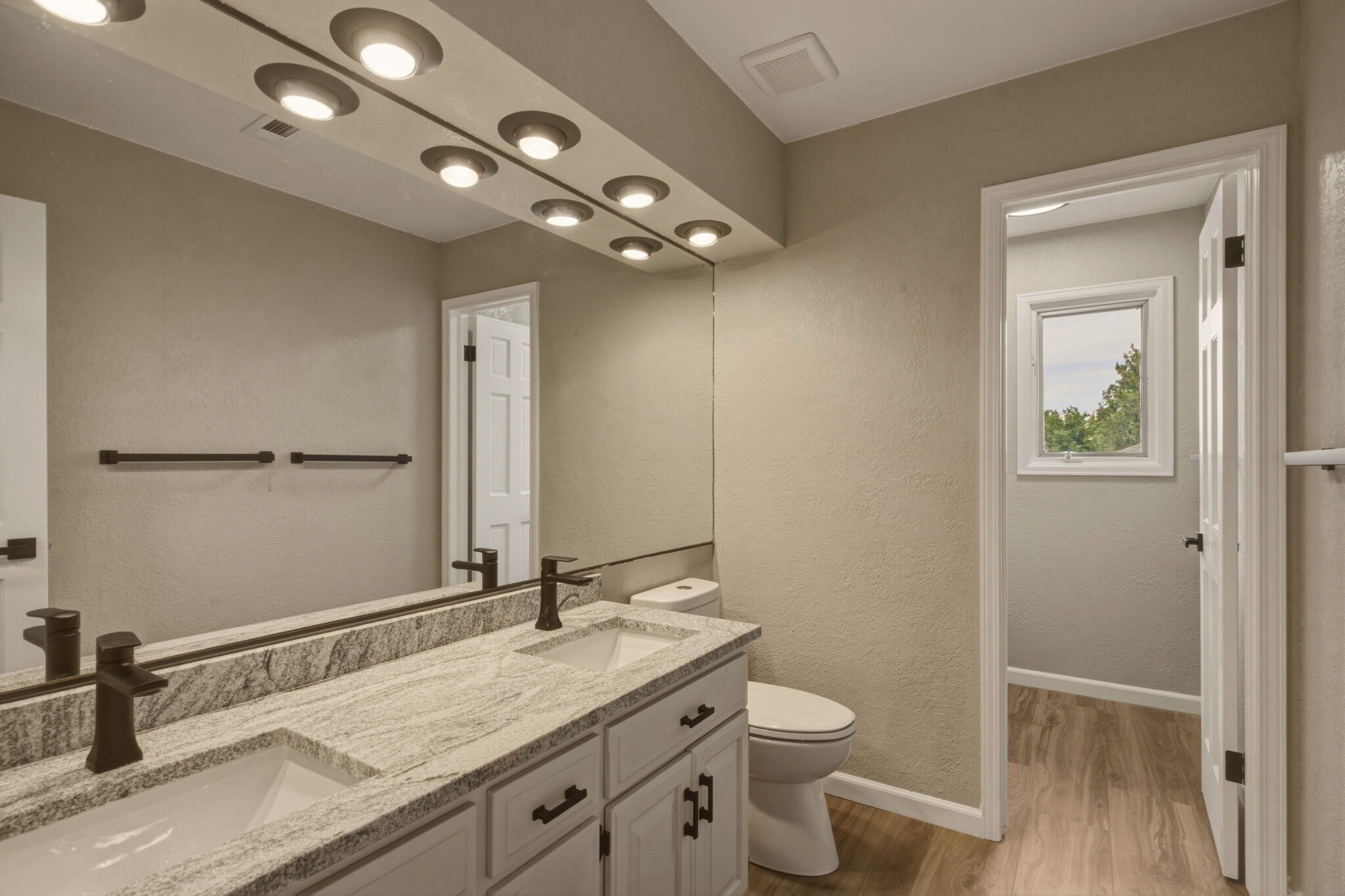 Upper hall bath with double sinks and granite counters