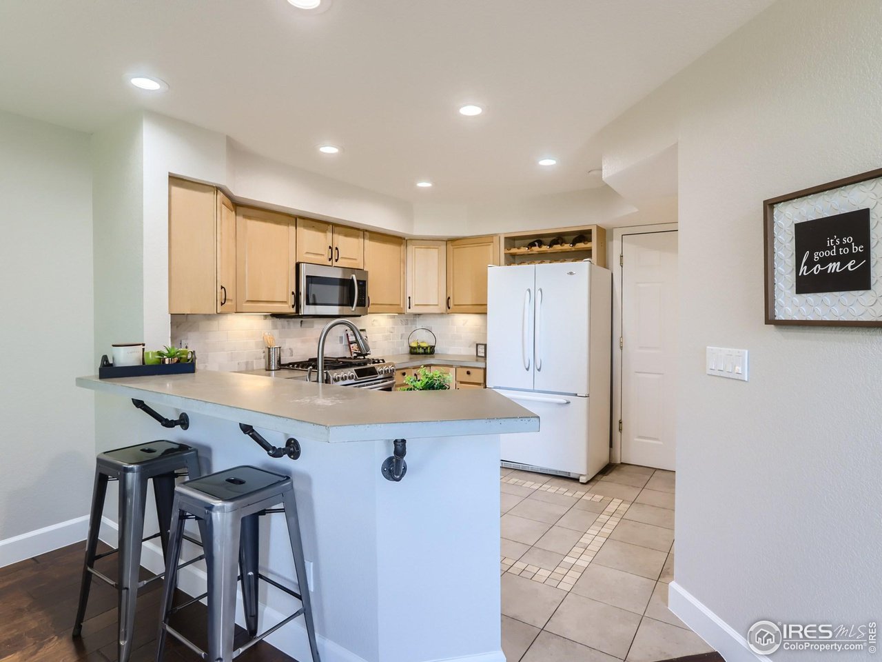 Gas stove, concrete counters and huge walk in pantry makes this kitchen spacious and workable.