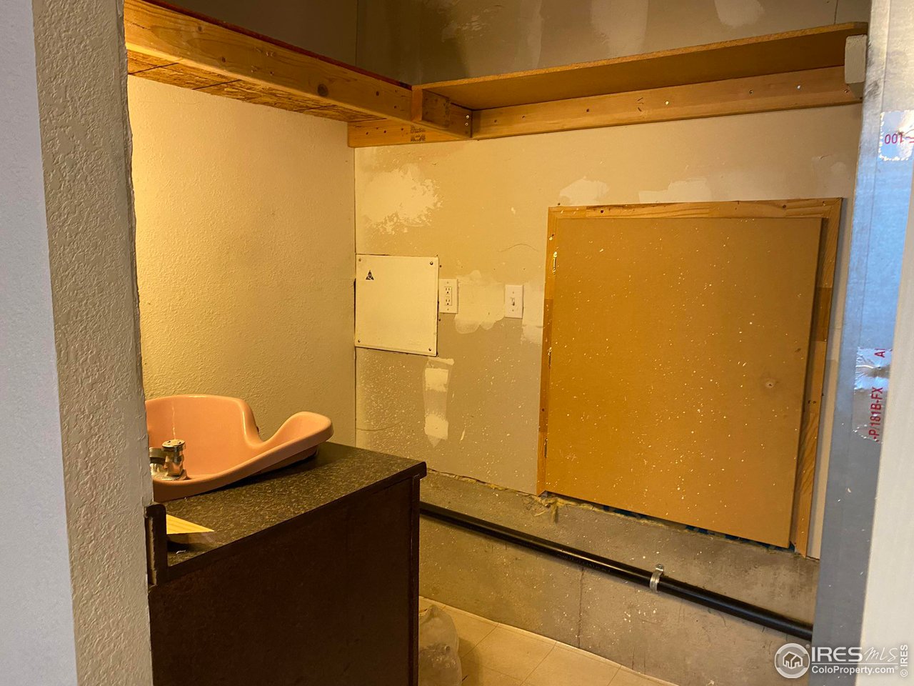 Access to crawl space and hairdressing sink. Located in Utility closet in basement
