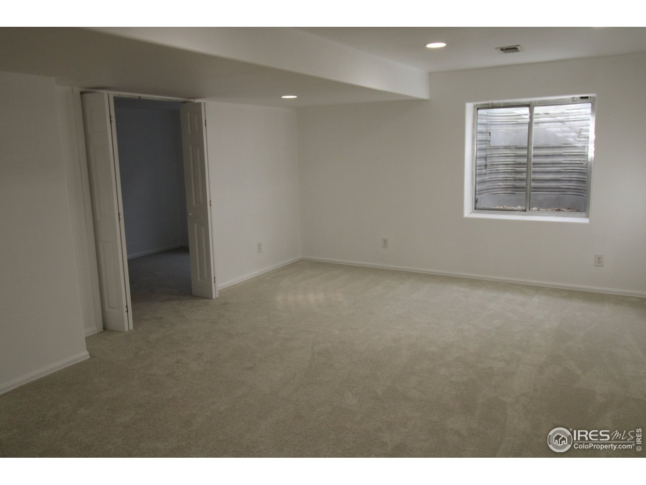 Big rec-room in basement with brand new carpeting.