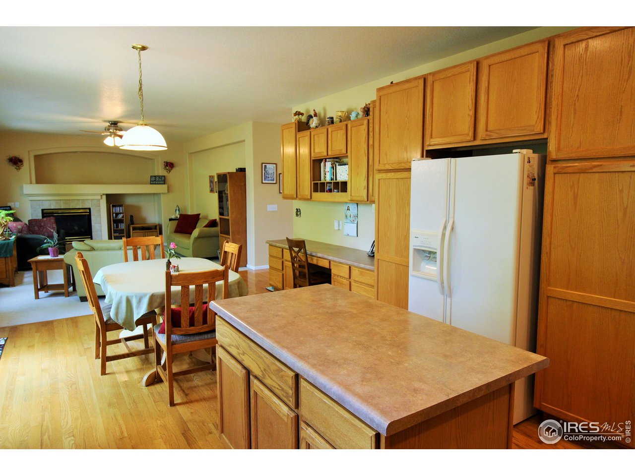 Cooks kitchen with center island, double ovens, cooktop, built-in microwave and stainless dishwasher.
