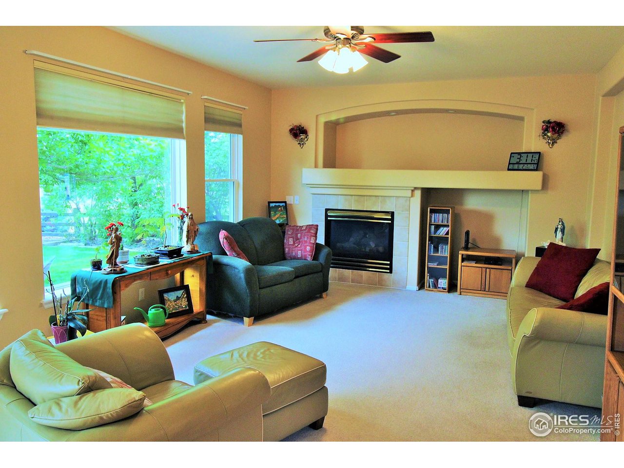 Big family room on main level with gas fireplace and ceiling fan, upgraded windows looking into back yard.